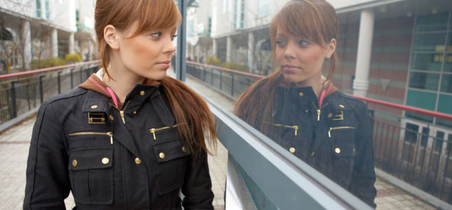 starts with me: young woman looking at reflection